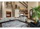 Open-concept living room with exposed beams, stone accents, and views into the kitchen area at 5764 Aspen Falls Cir, Las Vegas, NV 89149