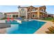 Beautiful pool with slide, hot tub, and outdoor seating in backyard oasis at 5764 Aspen Falls Cir, Las Vegas, NV 89149