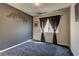 Bedroom with plush carpet, a dark accent wall, and a window with decorative curtains at 6074 Gordon Creek Ave, Las Vegas, NV 89139