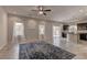 Open-concept living room featuring tile flooring, large windows, and seamless flow to the kitchen at 6074 Gordon Creek Ave, Las Vegas, NV 89139