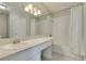 All-white bathroom featuring a large mirror, white vanity, and shower-tub combination at 6250 W Flamingo Rd # 43, Las Vegas, NV 89103