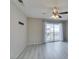 Inviting bedroom featuring a sliding glass door, modern ceiling fan, and sleek gray floors at 6250 W Flamingo Rd # 43, Las Vegas, NV 89103