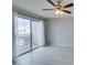 Airy bedroom with sliding glass doors, modern ceiling fan, and stylish gray floors at 6250 W Flamingo Rd # 43, Las Vegas, NV 89103