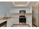 Contemporary kitchen showing stainless appliances, white cabinets, and view to living area at 6250 W Flamingo Rd # 43, Las Vegas, NV 89103