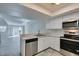 Open floor plan with modern kitchen, stainless appliances, and views to the living room at 6250 W Flamingo Rd # 43, Las Vegas, NV 89103