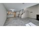 Open-concept living area with modern lighting, tile flooring, stairs and kitchen view at 6250 W Flamingo Rd # 43, Las Vegas, NV 89103
