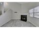 Living room showcases a fireplace, tile flooring, staircase, and natural lighting at 6250 W Flamingo Rd # 43, Las Vegas, NV 89103