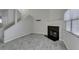 Bright living room featuring a fireplace, wood-look tile flooring, and a staircase at 6250 W Flamingo Rd # 43, Las Vegas, NV 89103