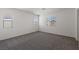 Bright bedroom with carpet, neutral paint, and natural light from two windows at 6269 Blood Lily Ave, Las Vegas, NV 89122