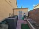 This backyard features air conditioning units and a storage shed against a brick wall at 6567 Fieldmouse Ave, Las Vegas, NV 89142