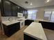 Well-equipped kitchen featuring dark cabinetry, white countertops, and modern appliances at 6567 Fieldmouse Ave, Las Vegas, NV 89142