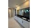 Contemporary bathroom with dual sinks, black granite countertop, and a shower with tile surround at 7142 Twilight Rider Ct, Las Vegas, NV 89118