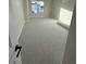 Bright bedroom featuring neutral walls, carpeted floor, and a window providing natural light at 7142 Twilight Rider Ct, Las Vegas, NV 89118