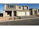 Two-story home with a two-car garage and a modern stone facade at 7142 Twilight Rider Ct, Las Vegas, NV 89118