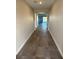 A hallway with tile flooring and an open view of the living area at 7142 Twilight Rider Ct, Las Vegas, NV 89118