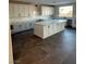 Modern kitchen featuring white cabinets, center island, and stone countertops at 7142 Twilight Rider Ct, Las Vegas, NV 89118