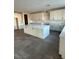 An open kitchen with a center island, white cabinets, and gray tile floors at 7142 Twilight Rider Ct, Las Vegas, NV 89118
