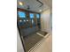 Modern shower featuring dark tile surround, unique floor tile, and glass enclosure at 7142 Twilight Rider Ct, Las Vegas, NV 89118