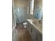 Modern bathroom features a glass shower, wood flooring, and a quartz countertop at 7199 Twilight Rider Ct, Las Vegas, NV 89118