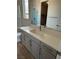 Bathroom featuring a glass shower, white cabinets, a large mirror, and wood-look tile flooring at 7199 Twilight Rider Ct, Las Vegas, NV 89118