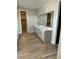 Bathroom with double vanity, gray cabinets, quartz countertop, and wood-look tile flooring at 7199 Twilight Rider Ct, Las Vegas, NV 89118