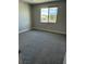 Neutral bedroom featuring carpet flooring, a double hung window and a neutral paint color at 7199 Twilight Rider Ct, Las Vegas, NV 89118