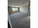 Expansive carpeted bedroom features a scenic outdoor view through an expansive window at 7199 Twilight Rider Ct, Las Vegas, NV 89118
