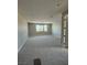 Upstairs bonus room with neutral carpet, recessed lighting, and a large window at 7199 Twilight Rider Ct, Las Vegas, NV 89118