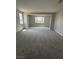 Spacious bonus room featuring neutral carpeting and large windows with plenty of natural light at 7199 Twilight Rider Ct, Las Vegas, NV 89118