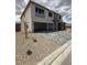 Two-story home with a gray brick driveway and a three-car garage in a modern style at 7199 Twilight Rider Ct, Las Vegas, NV 89118