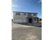 Two-story home featuring a two-car garage, stone accents, and neutral color palette at 7199 Twilight Rider Ct, Las Vegas, NV 89118