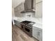 Modern kitchen featuring stainless steel appliances, gas range, gray cabinets, and quartz countertops at 7199 Twilight Rider Ct, Las Vegas, NV 89118