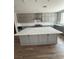 Gorgeous kitchen with large island, white quartz countertops, and gray cabinetry at 7199 Twilight Rider Ct, Las Vegas, NV 89118