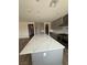 Spacious kitchen with a large island, gray cabinets, stainless steel appliances, and quartz countertops at 7199 Twilight Rider Ct, Las Vegas, NV 89118