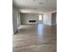 Open living room featuring tile floors, a modern fireplace, and plenty of natural light at 7199 Twilight Rider Ct, Las Vegas, NV 89118