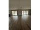 Bright living room features beautiful hardwood floors and sliding glass doors to the backyard at 7199 Twilight Rider Ct, Las Vegas, NV 89118