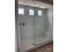 Modern walk-in shower with marble-look tile, frameless glass, and a built-in bench at 7199 Twilight Rider Ct, Las Vegas, NV 89118