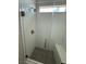 Glass enclosed shower with white textured tile, built in bench, and hexagon floor tiles at 7199 Twilight Rider Ct, Las Vegas, NV 89118