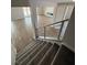 Carpeted staircase with metal railing overlooking the living room and entry to backyard at 7199 Twilight Rider Ct, Las Vegas, NV 89118