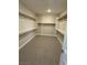 Walk-in closet with carpet flooring and wood shelving at 7199 Twilight Rider Ct, Las Vegas, NV 89118