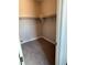 Walk-in closet with carpet flooring, white trim and built-in shelving with hanging rods at 7199 Twilight Rider Ct, Las Vegas, NV 89118