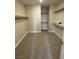 Walk-in closet with carpet flooring and wood shelving at 7199 Twilight Rider Ct, Las Vegas, NV 89118