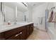 Bathroom featuring dual sinks, a large mirror, and a combined shower and tub at 7544 Nicklin St, Las Vegas, NV 89143