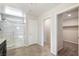 Bathroom with walk in shower, gray tile flooring and view of the walk in closet at 7629 Rosebark Cliffs St, North Las Vegas, NV 89084