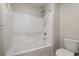 A clean, bright bathroom with a white tiled shower-tub combination at 7629 Rosebark Cliffs St, North Las Vegas, NV 89084