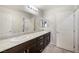 Bathroom featuring double sinks with granite vanity, tile floors and great lighting at 7629 Rosebark Cliffs St, North Las Vegas, NV 89084