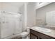 Bright bathroom featuring a walk-in shower with glass door and granite vanity top at 7629 Rosebark Cliffs St, North Las Vegas, NV 89084