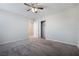 A bright bedroom with carpet flooring, closet, and a ceiling fan at 7629 Rosebark Cliffs St, North Las Vegas, NV 89084