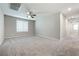 Bedroom with carpet, ceiling fan, and multiple doorways at 7629 Rosebark Cliffs St, North Las Vegas, NV 89084