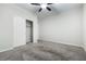 Bedroom with neutral carpet and ceiling fan, with a view of the closet at 7629 Rosebark Cliffs St, North Las Vegas, NV 89084